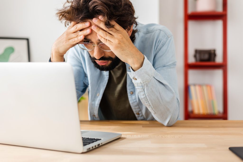 demonstrating headache and stress experienced by many overwhelmed business owners